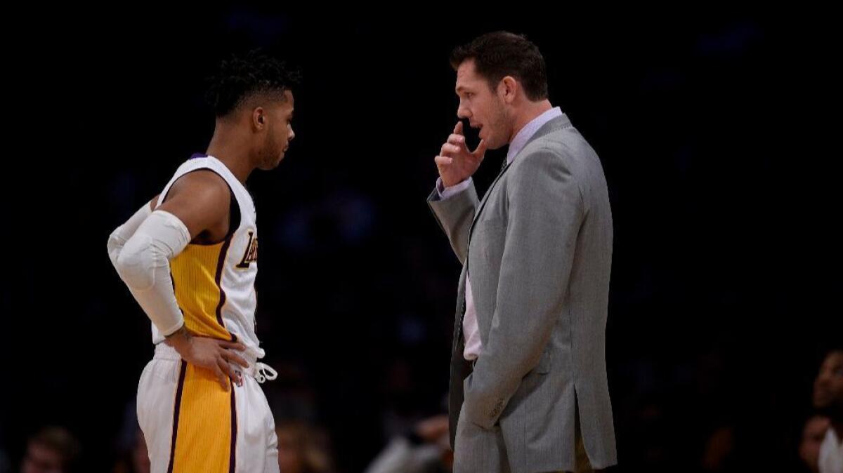 Lakers Coach Luke Walton talks with guard D'Angelo Russell during the first half of a game against the Raptors on Jan. 1.