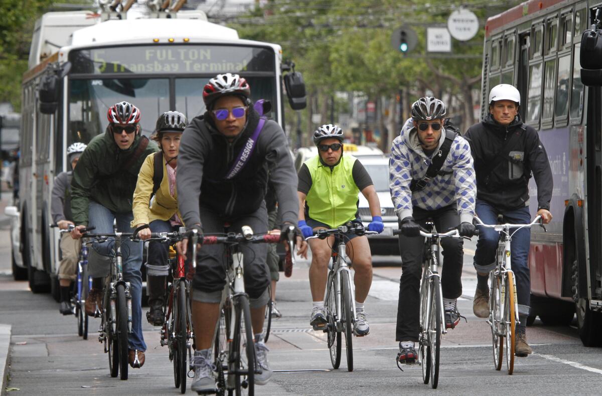 The California Air Resources Board wants cities to compete in fighting climate change by signing up residents to log actions they are taking to cut carbon emissions. Above, bicyclists during a morning commute on Market Street in San Francisco.
