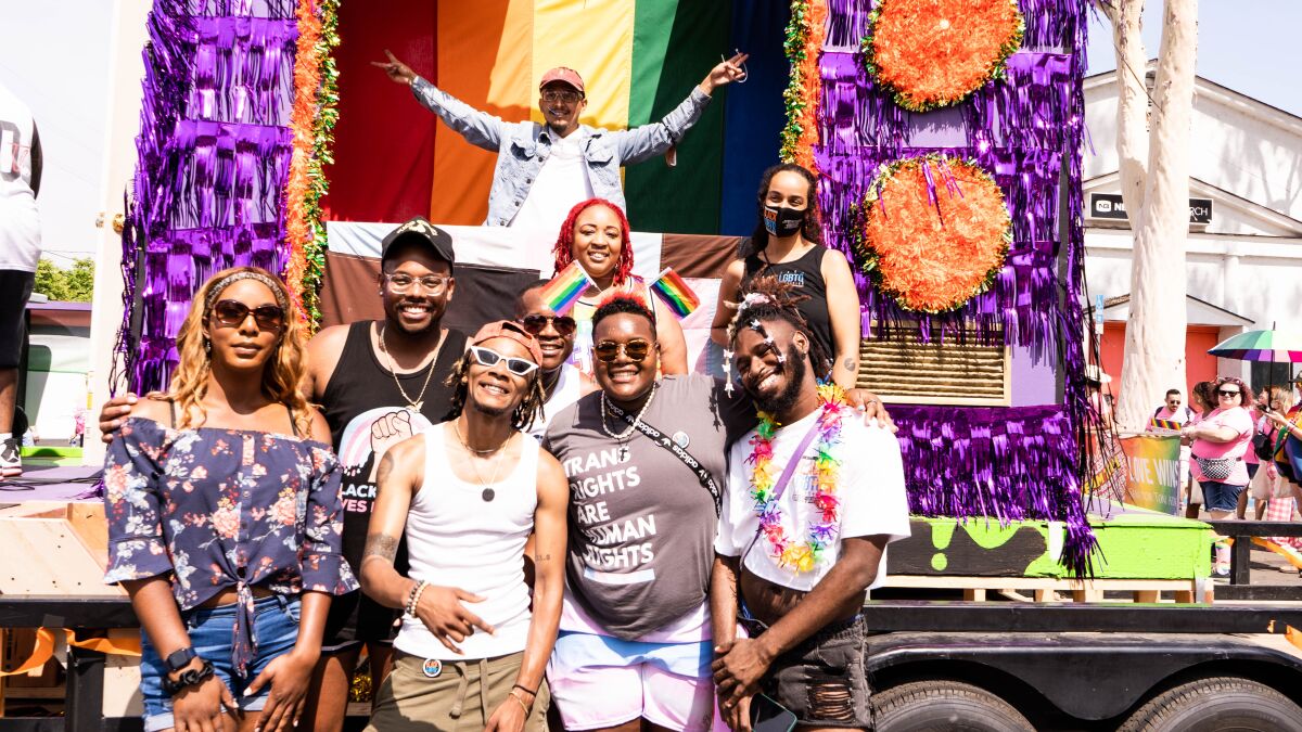 Members of the San Diego Black LGBTQ Coalition stand in front of their Pride float at San Diego Pride on July 16, 2022.