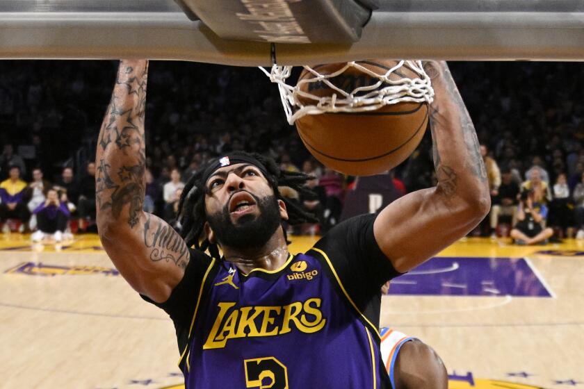 Los Angeles Lakers forward Anthony Davis dunks during the second half of an NBA basketball game against the Oklahoma City Thunder Friday, March 24, 2023, in Los Angeles. (AP Photo/Mark J. Terrill)