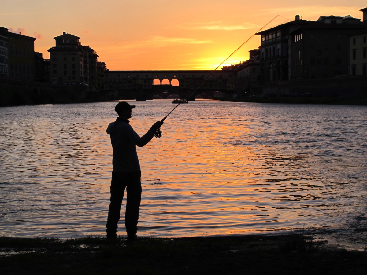 A fly-fisherman raises his rod along the banks of Tuscany's Arno River, which runs through Florence and the nearby Valdarno area.