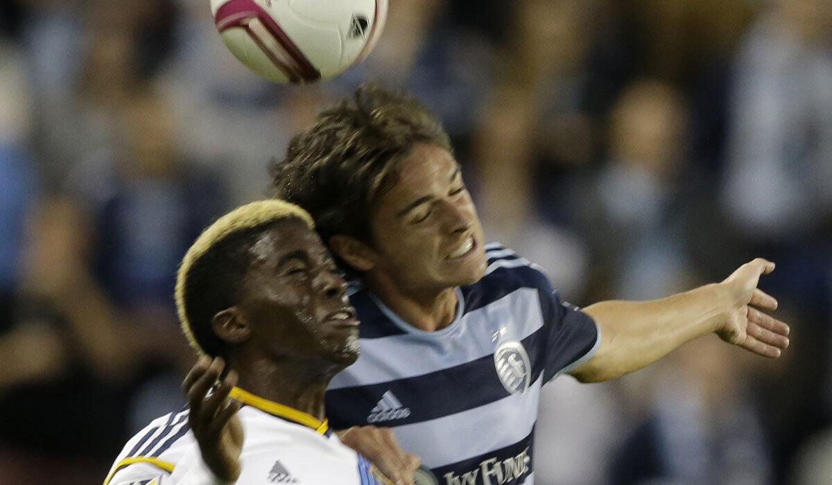 Sporting Kansas City forward Krisztian Nemeth, back, heads ball over Galaxy's Gyasi Zardes.