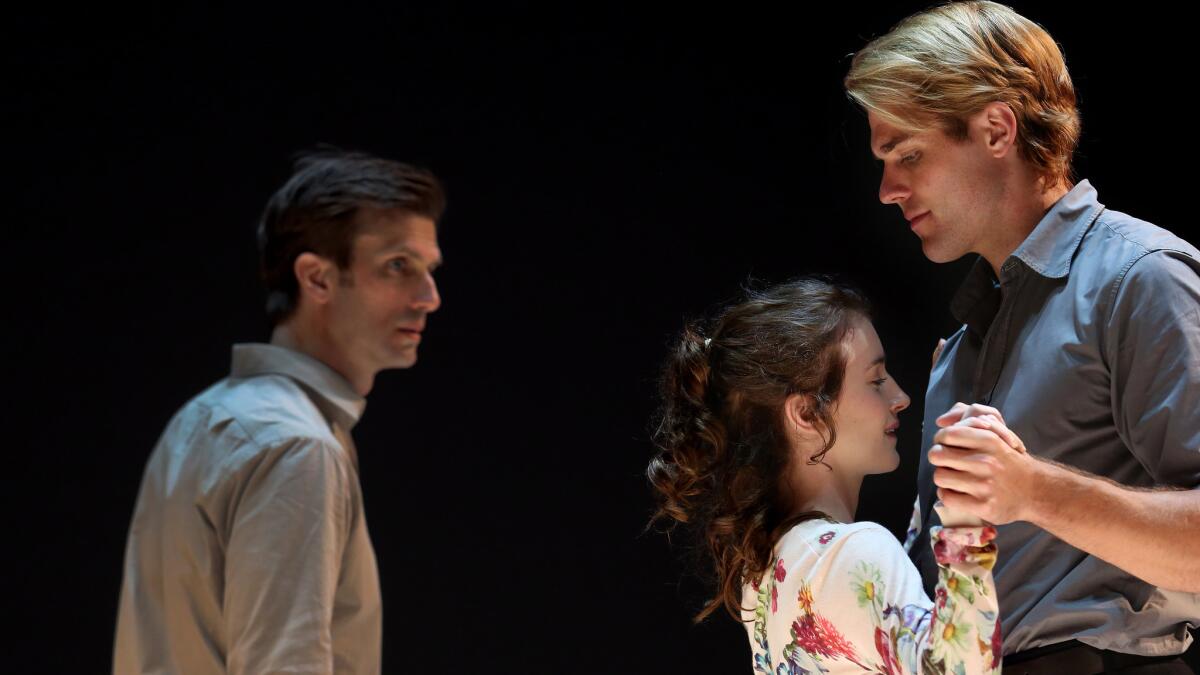 Eddie (Frederick Weller) looks on as Catherine (Catherine Combs) is held by Rodolpho (Dave Register) in director Ivo van Hove's production of Arthur Miller's "A View From the Bridge" at the Ahmanson Theatre.