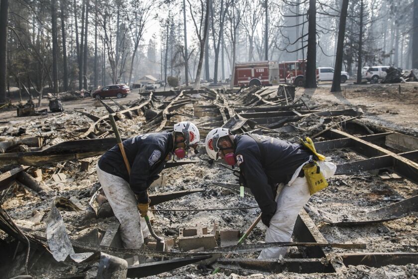PARADISE, CALIF. -- TUESDAY, NOVEMBER 20, 2018: A Search and rescue team carefully scan the area where there might be suspected human remains after the Camp Fire destroyed most of Paradise, Calif., on Nov. 20, 2018. (Marcus Yam / Los Angeles Times)