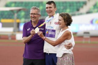 Geoff and Susan Wightman pose with their son Gold medalist Jake Wightman.