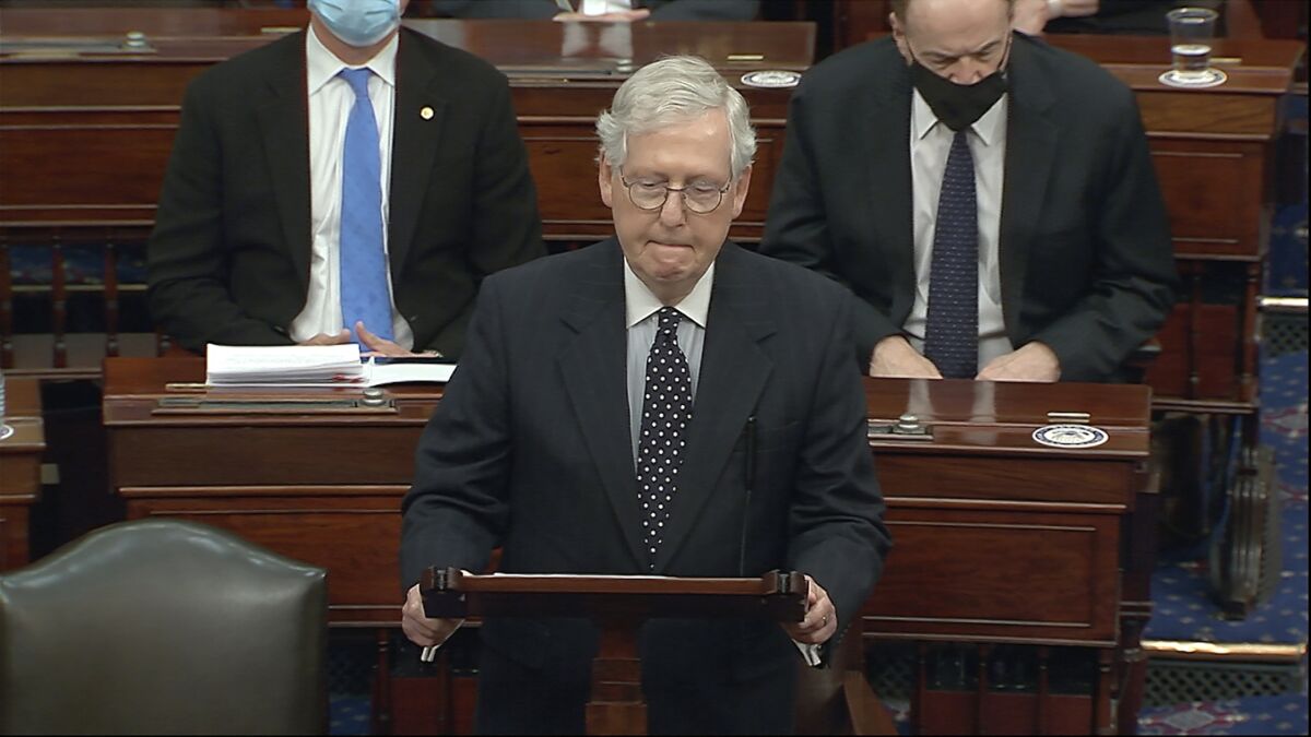 Senate Majority Leader Mitch McConnell (R-Ky.) stands at a lectern in the Senate chamber. 