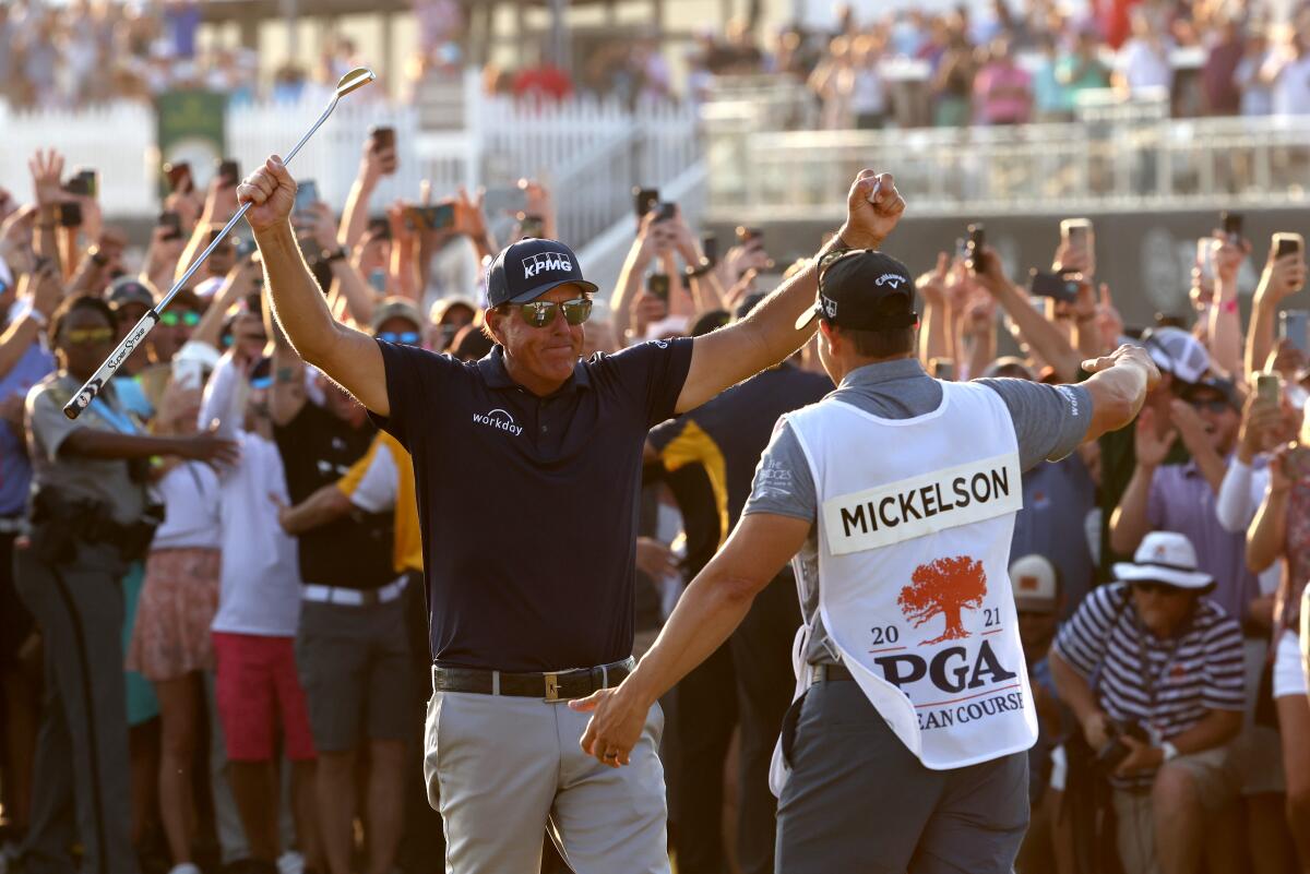 Phil Mickelson celebrates with brother and caddie Tim Mickelson upon winning the 2021 PGA Championship in Kiawah Island, S.C.