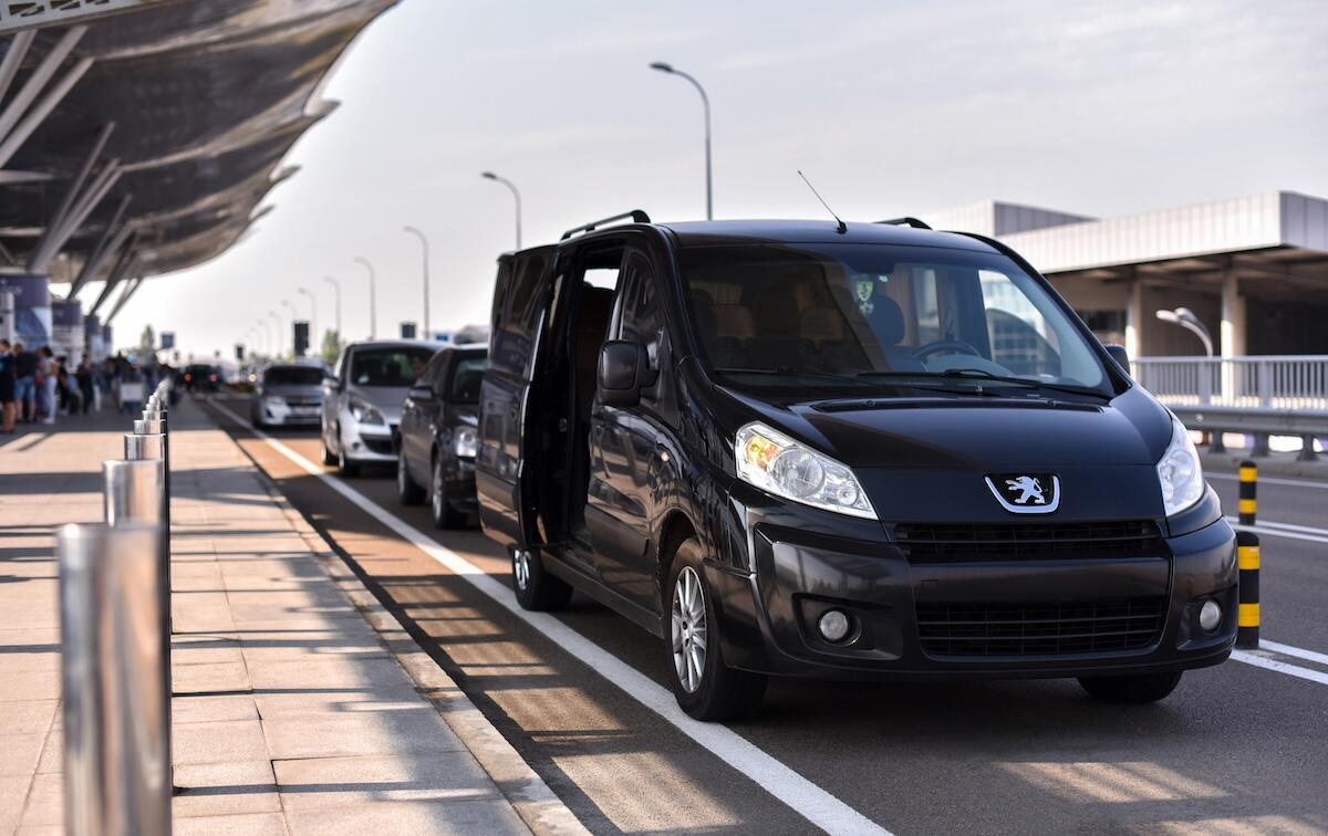 A black cab outside of an airport