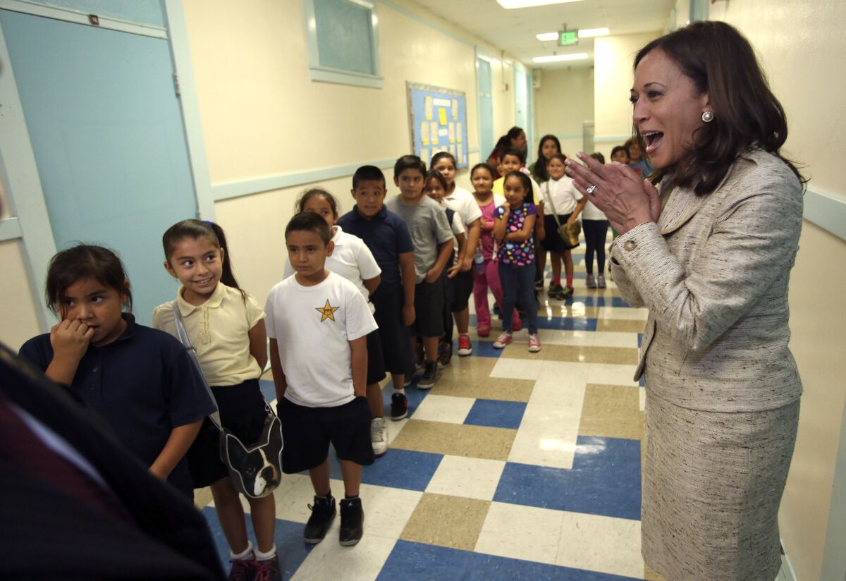 Atty. Gen. Kamala Harris, right, greets third-grade students after a news conference at Malabar Street Elementary School in Los Angeles, where she discussed her second annual report on elementary school truancy.
