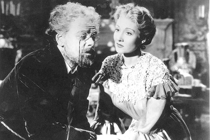 PAUL MUNI, left, and GLORIA HOLDEN in the movie THE LIFE OF EMILE ZOLA. It won an Academy Award for Best Picture in 1947. courtesy Warner Bros.