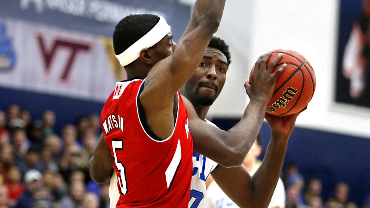 UCLA guard Isaac Hamilton tries to drive around Nebraska guard Glynn Watson Jr. during the first half of a Wooden Legacy semifinal game Friday night.