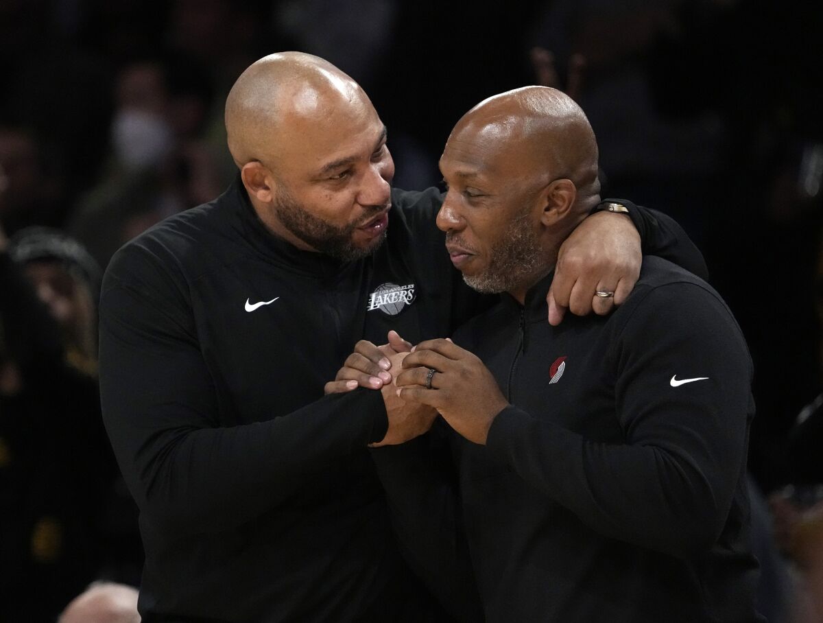 Coaches Darvin Ham of the Lakers and Chauncey Billups of the Portland Trail Blazers embrace after a game.