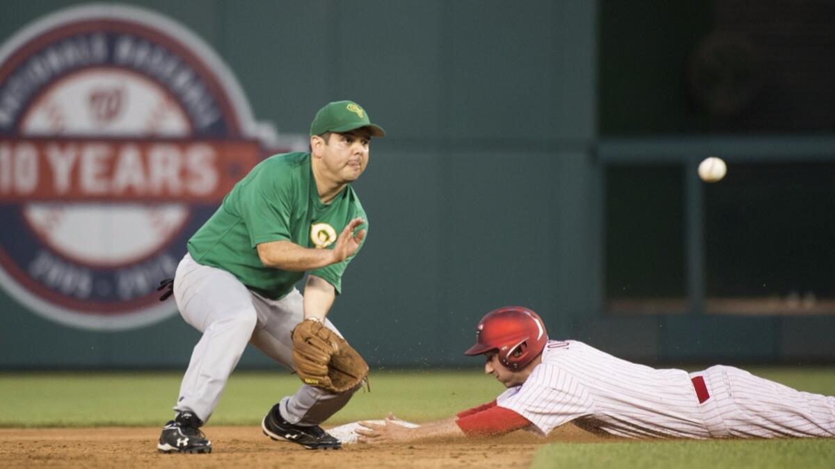 Rep. Raul Ruiz (D-Palm Desert) waits for a late throw as Rep. Ryan Costello (R-Pa.) slides safely at second base during the 54th Annual Roll Call Congressional Baseball Game. (Bill Clark / CQ Roll Call)