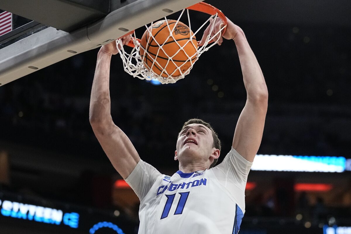 Creighton center Ryan Kalkbrenner (11) makes the dunk against Princeton in the second half of a Sweet 16 round college basketball game in the South Regional of the NCAA Tournament, Friday, March 24, 2023, in Louisville, Ky. (AP Photo/John Bazemore)