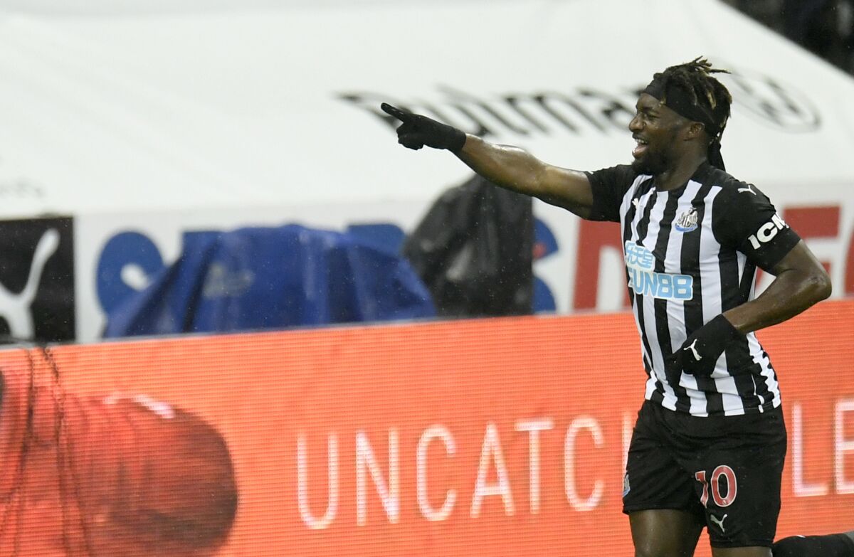 Newcastle's Allan Saint-Maximin celebrates after scoring his side's opening goal during the English Premier League soccer match between Newcastle United and Burnley at St. James' Park in Newcastle, England, Saturday, Oct. 3, 2020. (Peter Powell/Pool via AP)