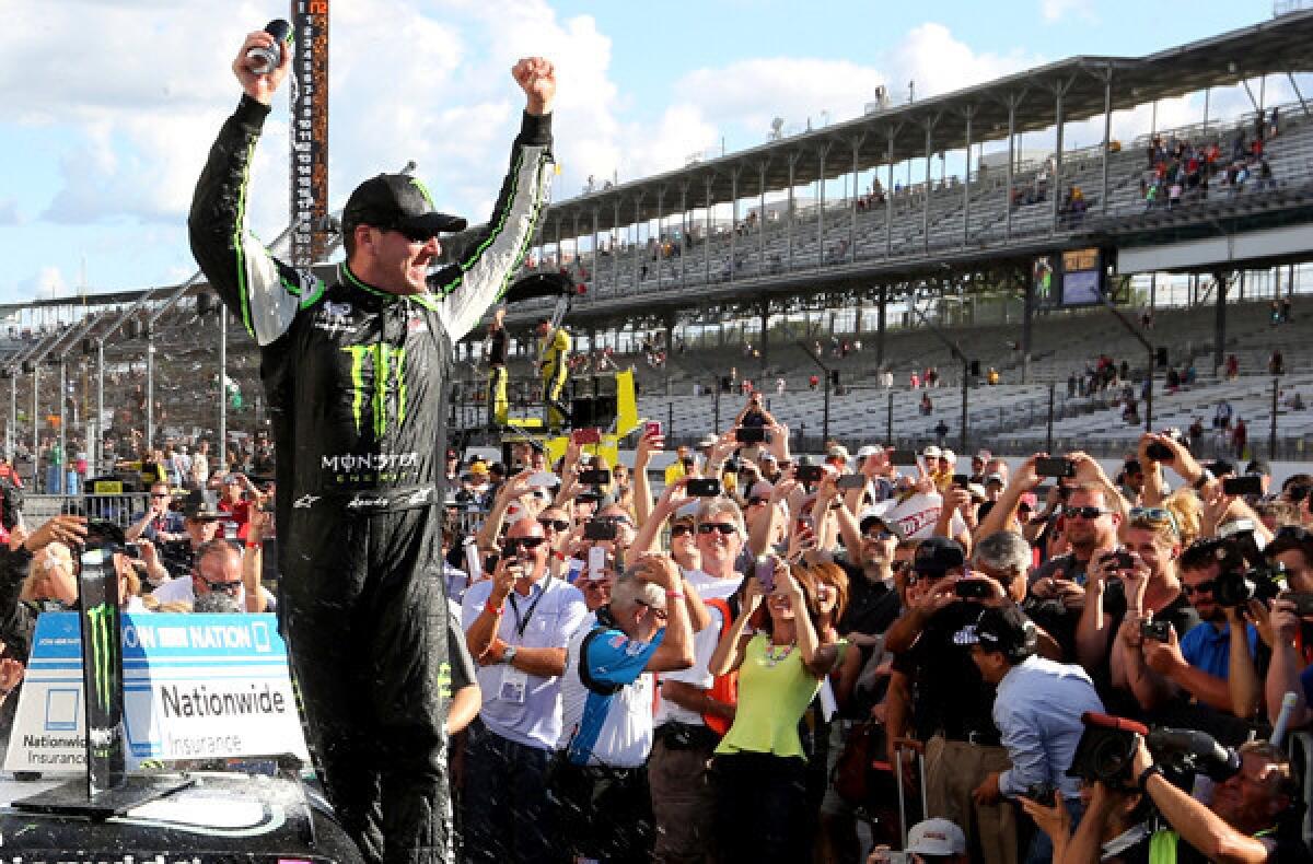 NASCAR Nationwide driver Kyle Busch celebrates in Victory Lane at Indianapolis Motor Speedway on Saturday after winning the Indiana 250.