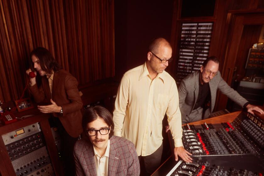 The band Weezer in the studio