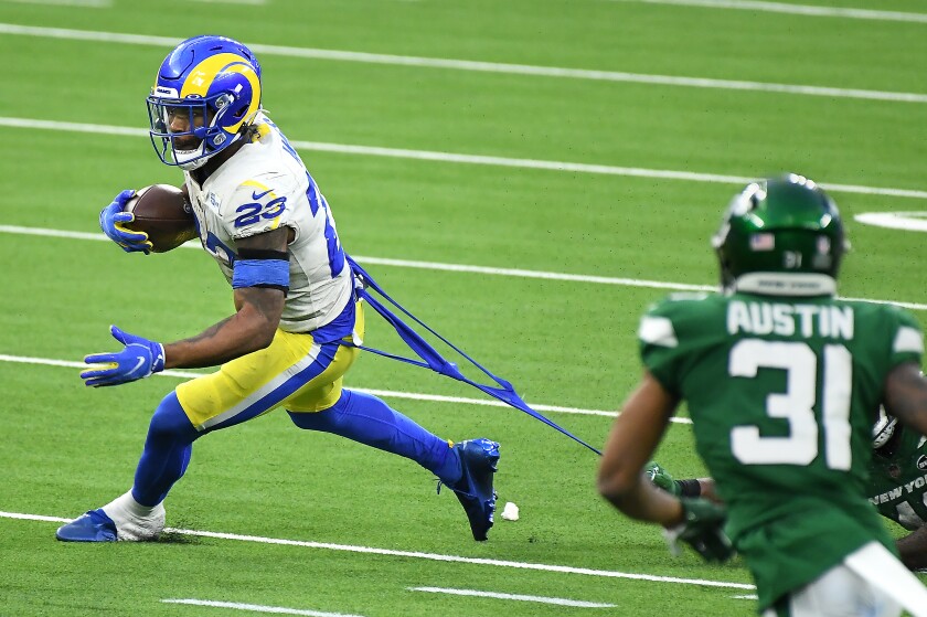 A New York Jets defender tries to pull down Rams running back Cam Akers during the Rams' loss on Sunday.