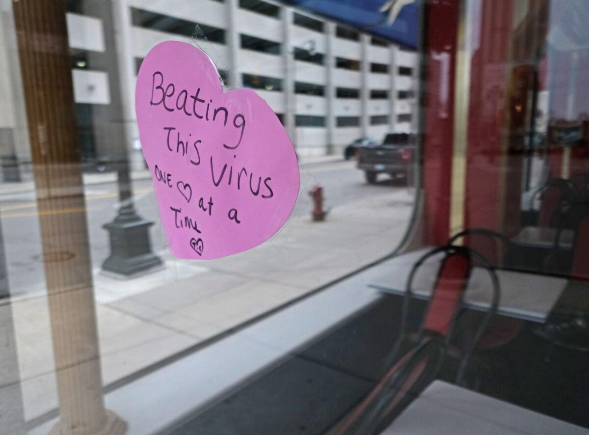 A sign hangs in the window of a Detroit restaurant last month. Michigan has been hard-hit by the pandemic.