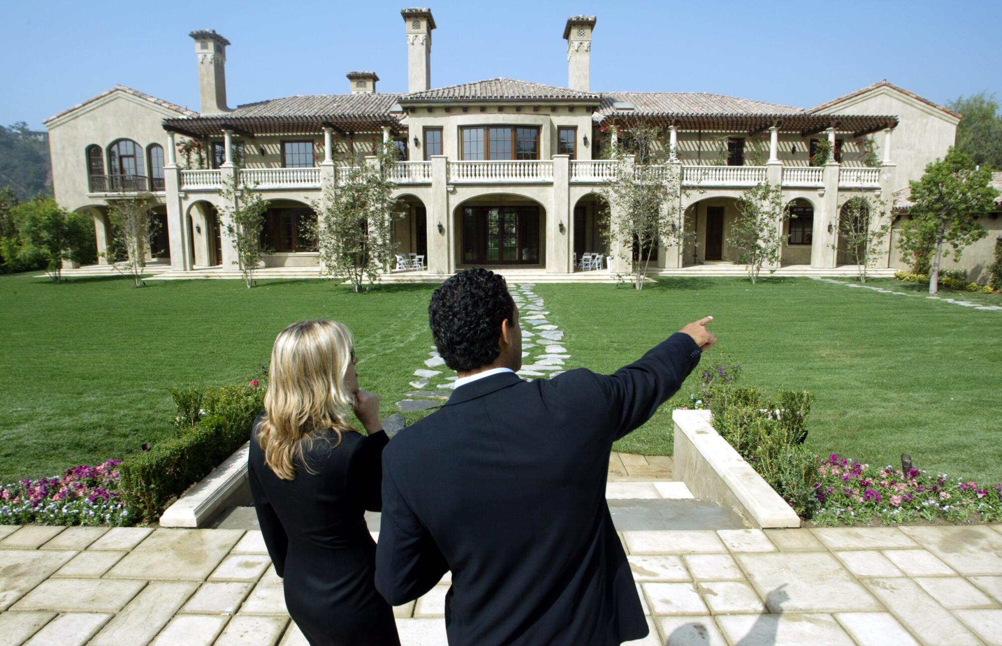 Realtors Mauricio Umansky, right, and Lea Jett in the gated community of Beverly Park.