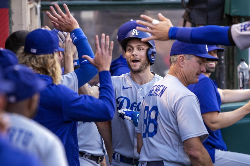 Los Angeles Dodgers' Trea Turner is congratulated for his solo home run against the Los Angeles Angels during the first inning of a baseball game in Anaheim, Calif., Saturday, July 16, 2022. (AP Photo/Alex Gallardo)