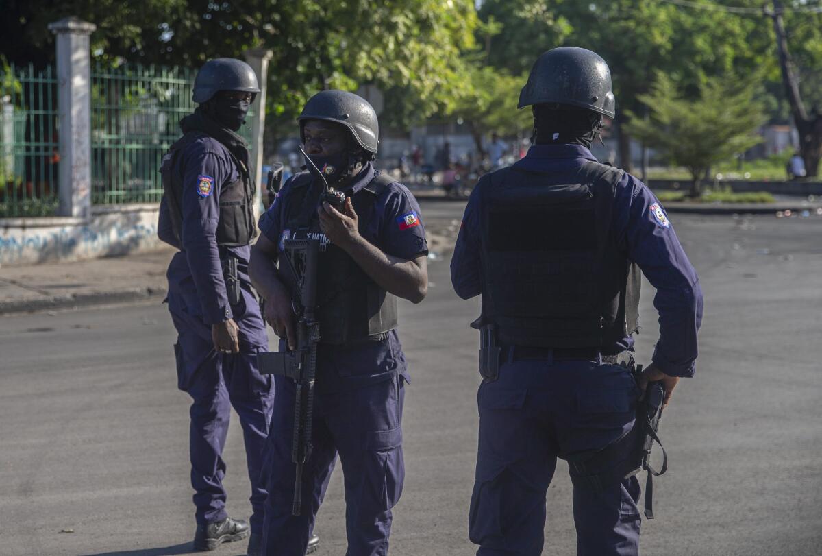 Three officers secure the area where the Haiti's Prime Minister Ariel Henry visited Oct. 17, 2021.