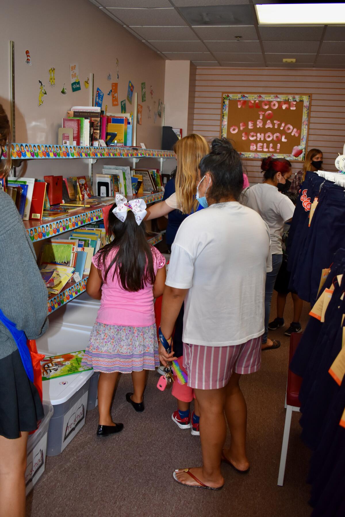 Students pick out a book from the Operation School Bell room.