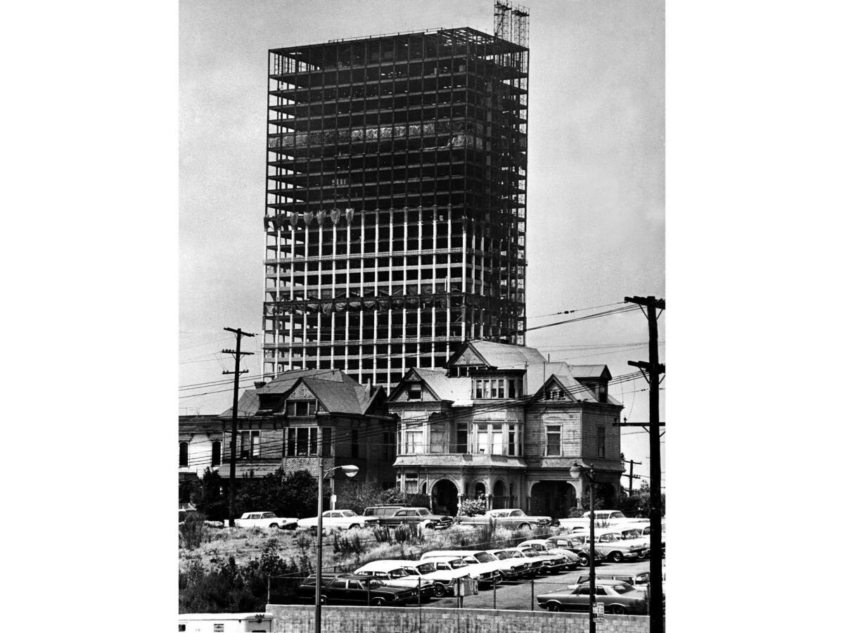 May 12, 1966: The skeleton of the 40-story Union Bank Square building rises over Bunker Hill Victorians. The Castle, on the right, was saved while the home on the left was demolished.