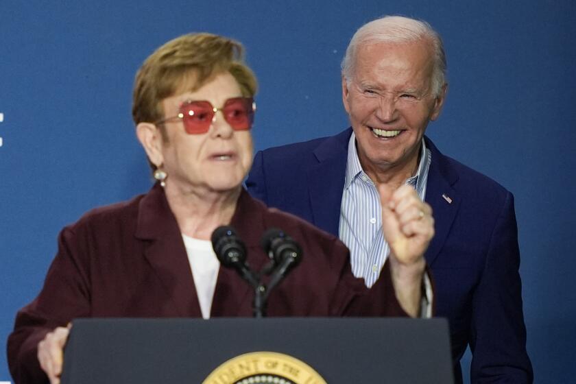 Elton John speaks as President Joe Biden listens at the grand opening ceremony for the Stonewall National Monument Visitor Center, Friday, June 28, 2024, in New York. (AP Photo/Julia Nikhinson)