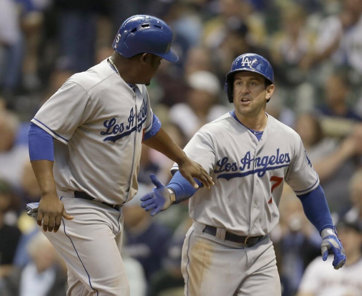 Juan Uribe, left, and Nick Punto celebrate after scoring on Carl Crawford's single in the second inning Wednesday.