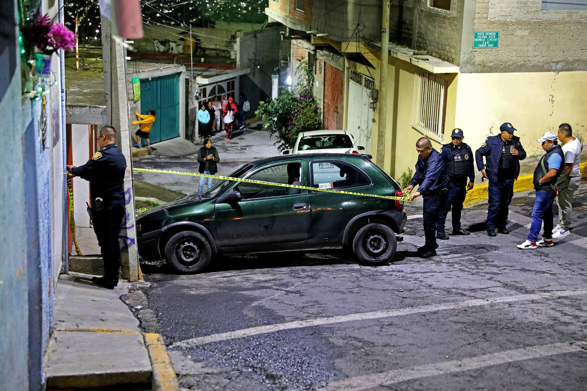 Mexico City police officers conduct an investigation where a male taxi driver was killed.