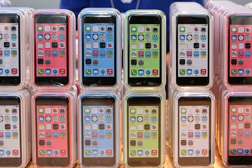 Rows of the iPhone 5c are displayed at an Apple store in 2013.