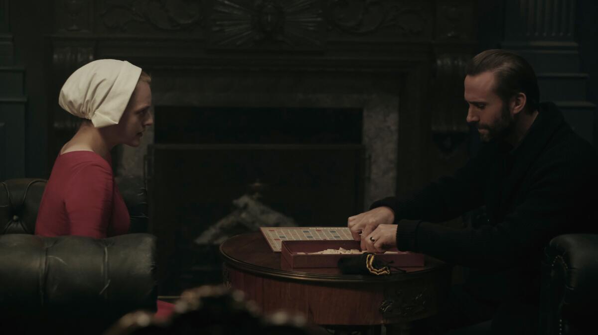 Elisabeth Moss and Joseph Fiennes play a monumental game of Scrabble in "The Handmaid's Tale." (George Kraychyk / Hulu)