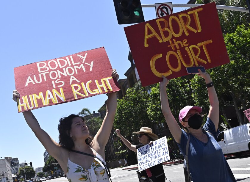 Activists march through downtown Los Angeles, on June 25, 2022, as they protest the Supreme Court's ruling on abortion.