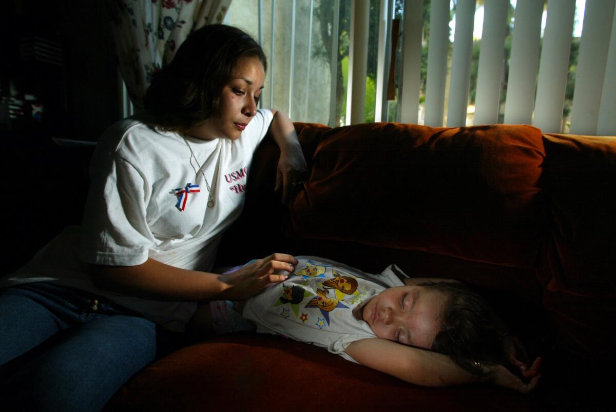 Ivonne Gonzalez, 18, widow of Jesus Gonzalez, in her Escondido apartment with their daughter Delilah, 2. (Mark Boster / Los Angeles Times)