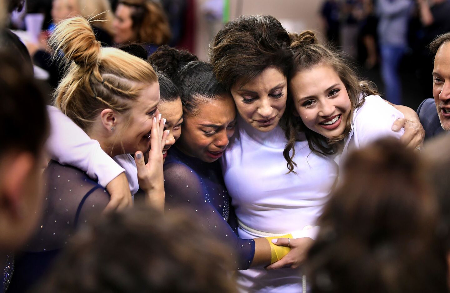 Coach Valorie Kondos Field, second from right, with, from left, Gracie Kramer, Anna Glenn, Margzetta Frazier and team manager Lila Waller after finishing third in the NCAA Gymnastics Championship at the Ft. Worth Convention Center Saturday.