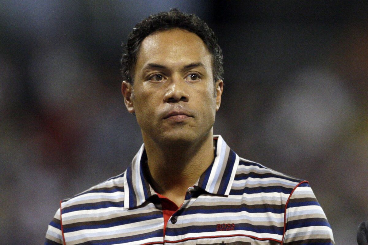 FILE - In this June 30, 2010, file photo, former Major League Baseball player Roberto Alomar looks on before the start of a baseball game between the New York Mets and the Florida Marlins in San Juan, Puerto Rico. the Hall of Fame second baseman has been fired as a consultant by Major League Baseball and placed on the league's ineligible list following an investigation into an allegation of sexual misconduct, Commissioner Rob Manfred announced Friday, April 30, 2021. (AP Photo/Andres Leighton, File)