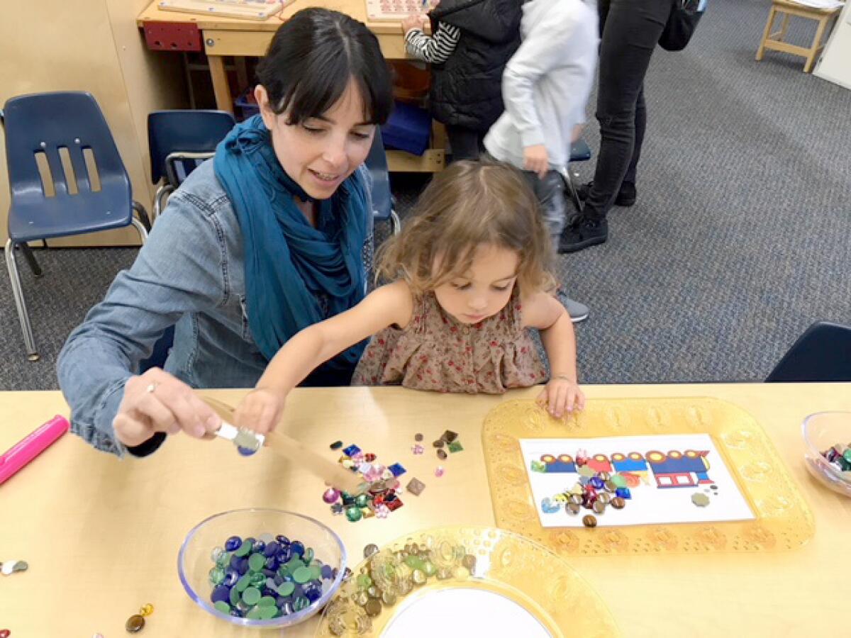 A Laguna Beach Unified School District student and parent participate in a Passport to Learning activity.