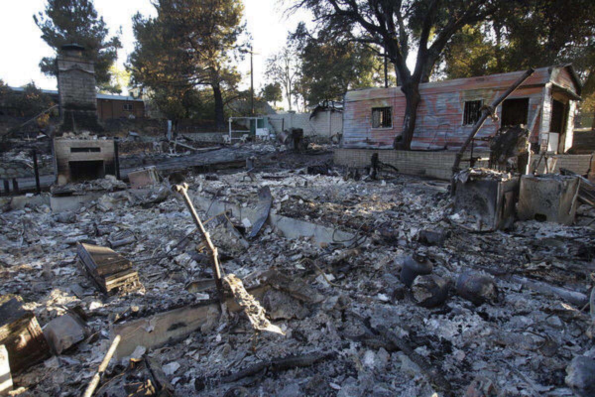 A chimney remains standing on the site of a burned-out home in the Poppet Flats neighborhood after the Silver fire raced through the area.