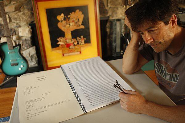 Composer Thomas Newman, with a copy of "It Got Dark," says growing up in a musical household was "complex, wonderful and a little scary."