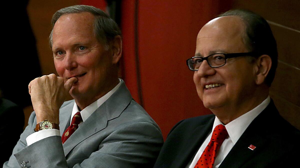 USC Athletic Director Pat Haden, left, and USC President Max Nikias look on during football coach Steve Sarkisian's introductory news conference in December. Haden and Nikias brought in outside help to strengthen its NCAA compliance efforts.