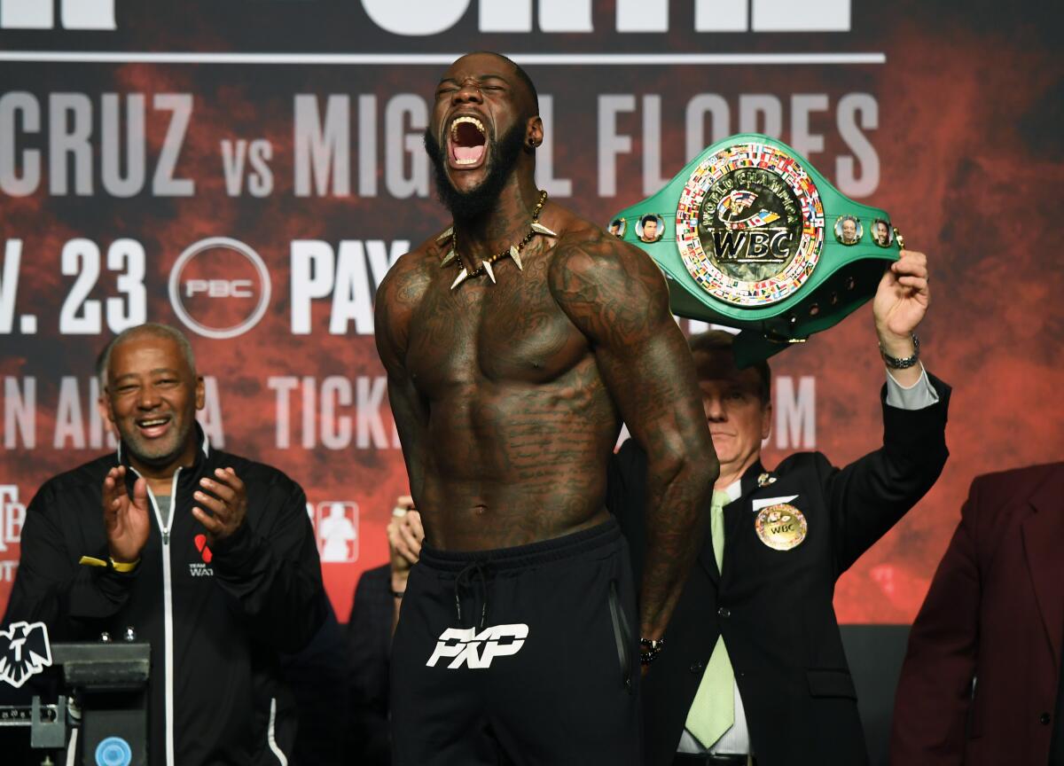 WBC heavyweight champion Deontay Wilder makes his signature bomb squad yell during his official weigh-in at MGM Grand Garden Arena on Friday in Las Vegas.