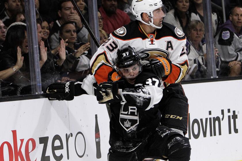 Kings rookie center Nick Shore battles along the boards with Ducks defenseman Francois Beauchemin during a preseason game at Staples Center.