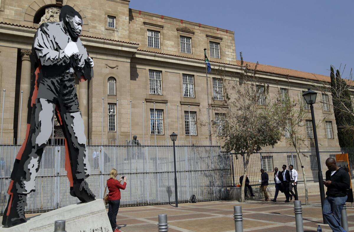 A sculpture of Nelson Mandela stands outside the Johannesburg courthouse where one of his grandsons appeared on rape charges on Aug. 21.