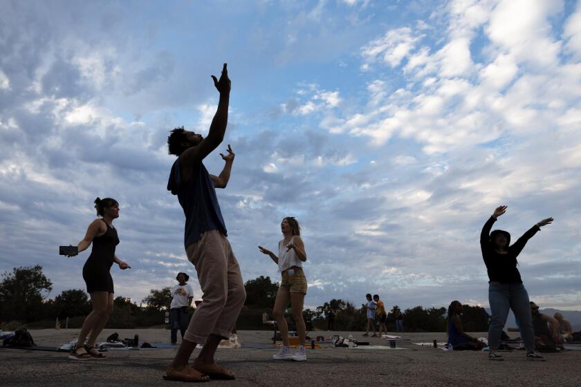 Participants dance at sunset during the Natural High alcohol-free party at Elysian Park.