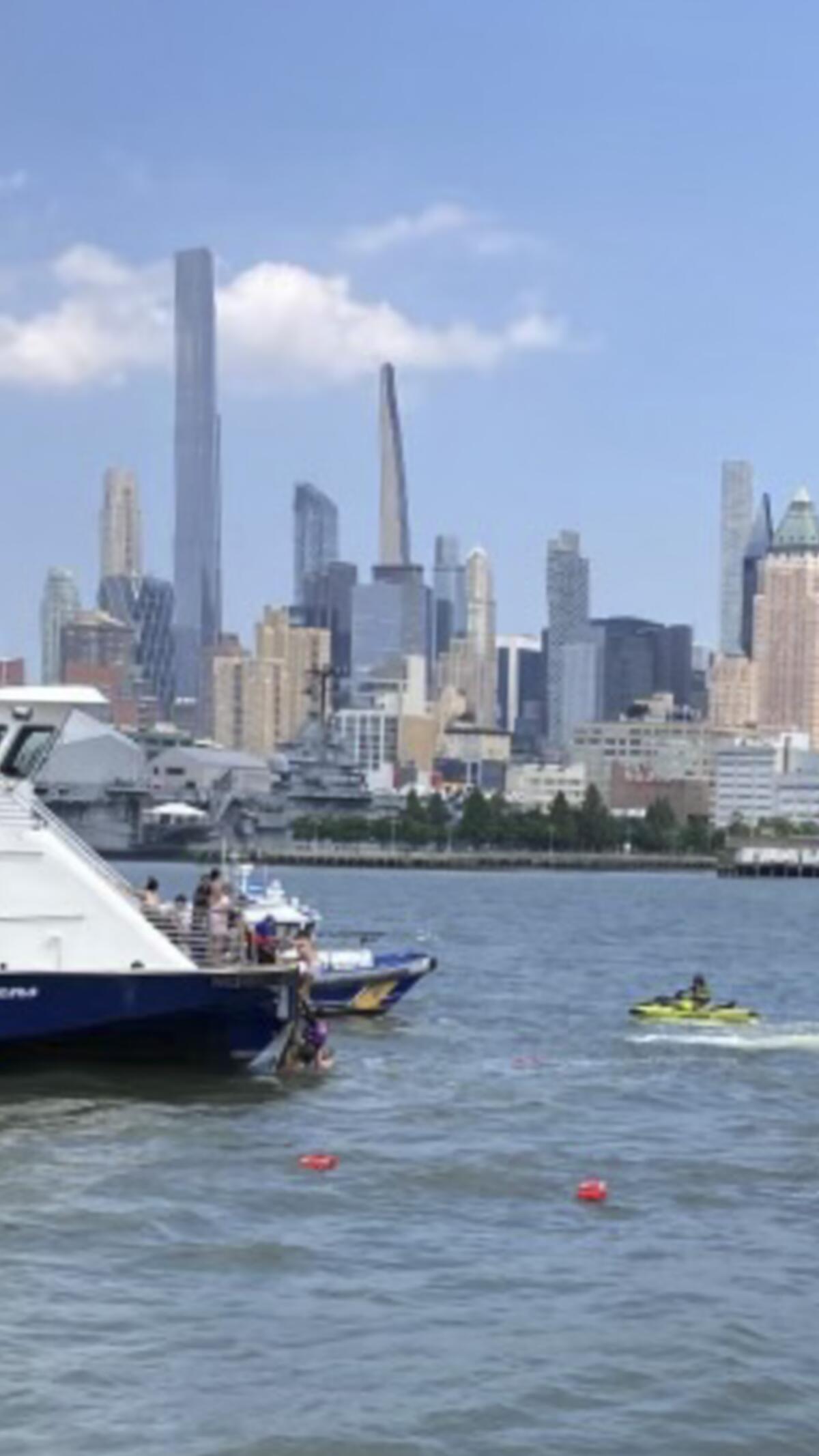 This photo provided by NY Waterway shows ferry personnel making rescue of individuals after a boat capsized in the Hudson River on Tuesday, July 12, 2022, in New York. (NY Waterway via AP)