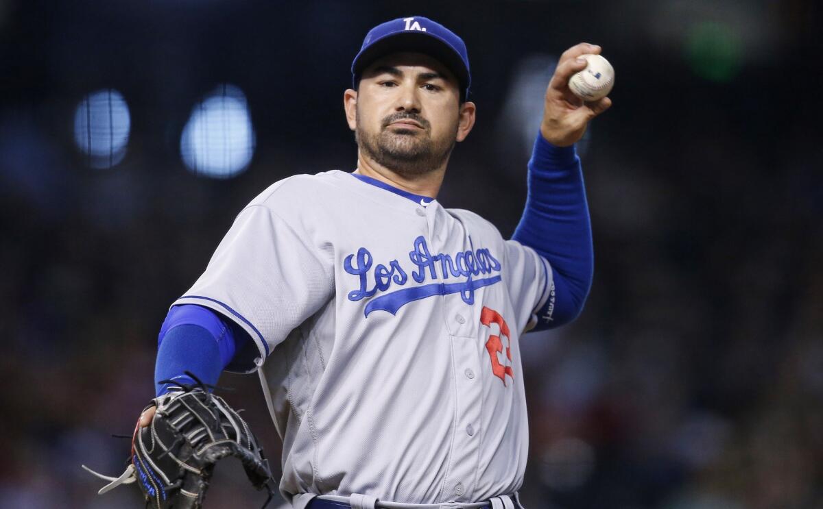 Dodgers first baseman Adrian Gonzalez throws a baseball to fans on June 15.