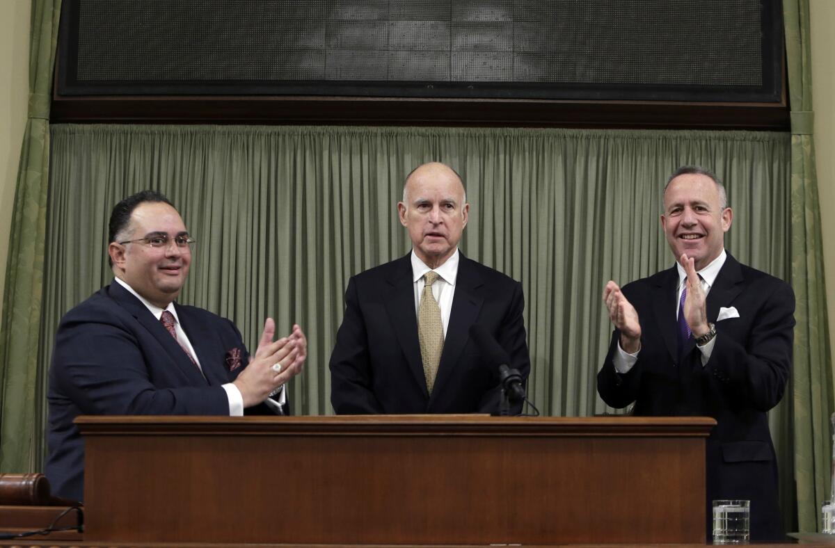 Gov. Jerry Brown, center, with Assembly Speaker John Perez, left, and Senate President Pro Tem Darrell Steinberg, has said in the past that changing Proposition 13 would be a "big fat loser."