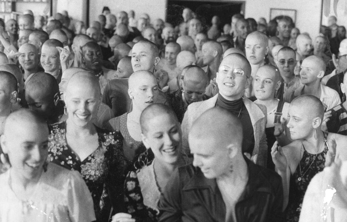 A group of women with shaved heads.