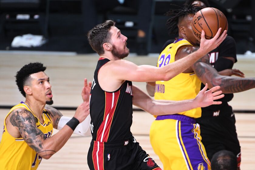ORLANDO, FLORIDA SEPTEMBER 30, 2020-Heat's Goran Dragic drives to the basket against Lakers Danny Green in Game 1 of the NBA FInals in Orlando Wednesday. (Wally Skalij/Los Angeles Times)